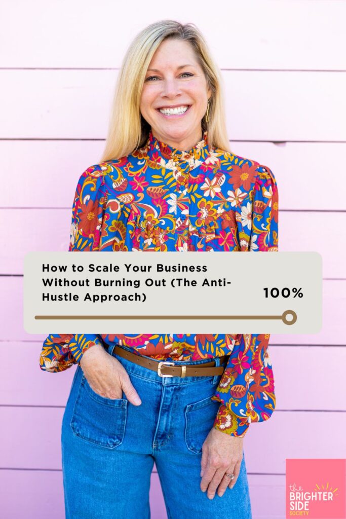 Angel Holmes, business mentor and founder of The Brighter Side Society, working at organized desk demonstrating sustainable business growth