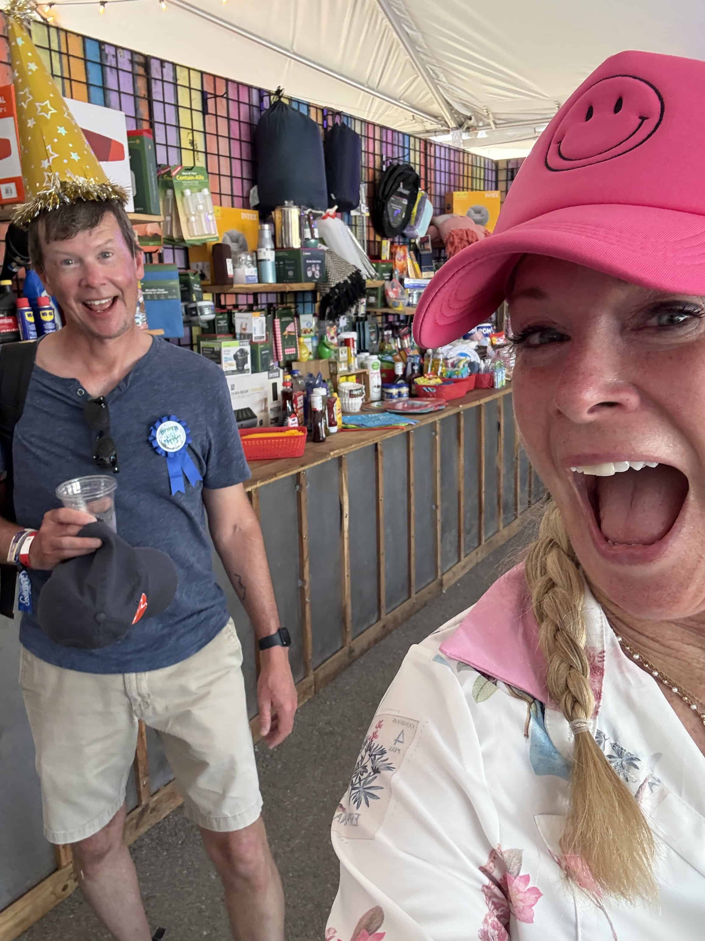 Angel and Brian Holmes in the Bourbon & Beyond camp store celebrating Brian’s birthday, an example of unreasonable hospitality
